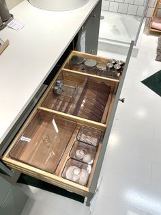 an open drawer in the middle of a kitchen counter