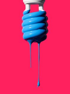 a blue spiral object on a pink background with water dripping from the top to the bottom