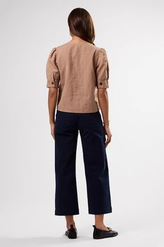 A feminine twist on the classic button-down, subtly cropped with a petite puff sleeve, perfect for pairing with high-waisted silhouettes for work or play.V-neck, short puff-sleeved blouse with cuff detail and urea button placket on the front52% Linen, 48% Organic Cotton22 1/2" in LengthSlightly cropped style, can be worn tucked-in or looseEthically Made in India Cotton Puff Sleeve V-neck Top For Work, Fitted V-neck Blouse With Button Cuffs, Fitted V-neck Puff Sleeve Top With Gathered Sleeves, Feminine Cotton Puff Sleeve Top With V-neck, Feminine Cotton V-neck Puff Sleeve Top, Cuff Detail, Cropped Style, Cuff Sleeves, Puff Sleeve