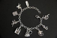 "A collection of silver plated fairy tale themed charms have been dispersed around a shimmering silver plated bracelet chain in this handmade charm bracelet. This fantasy storybook charm bracelet is then completed with a lobster clasp and a 1/2 inch of chain at the end for adjustable sizing. Charms in this bracelet include a \"Believe\" tab charm, pegasus charm, storybook charm, dragon charm, castle charm, princess charm with crown charm, unicorn charm, mermaid charm, and a fairy on the moon cha Princess Style Silver Jewelry Gift, Fantasy Style Silver Bracelet, Whimsical Silver Bracelet Jewelry, Whimsical Silver Dangling Charms, Whimsical Silver Charm Bracelet, Adjustable Silver Fantasy Bracelet, Whimsical Nickel-free Silver Charm Bracelet, Silver Fantasy Bracelet, Themed Silver Charm Bracelet