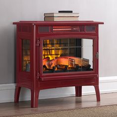 a red stove with the measurements for it