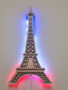 the eiffel tower is lit up with red, white and blue lights on it