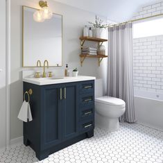 a white and blue bathroom with hexagonal floor tiles on the floor, gold accents