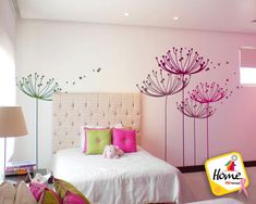 a bedroom with pink and green decor on the walls