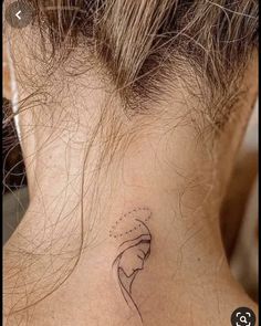 a woman's neck with a small tattoo on it