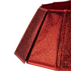 a red lamp shade is shown against a white background with no image to describe, it looks like the fabric has been sequinized