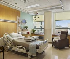 an empty hospital room with chairs and medical equipment