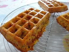 three waffles sitting on top of a metal rack