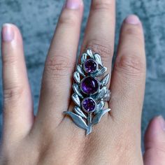 Amethyst silver ring, amethyst jewelry, lavender jewelry, handmade ring, artisan jewelry, crystal ring, purple gemstone ring, witchy jewelry Three amethyst gemstones lay in the middle of a lavender sprig. Each petal has been sawed by hand and attached to the stone bezels. I've also textured the petals and given the piece a soft satin finish. I've also oxidized the flower for contrast. The band of the ring is textured and wide, ensuring a comfortable fit. All components of the ring are hand fabri Lavender Jewelry, Lavender Jewellery, Raw Amethyst Ring, Raw Gemstone Ring, Ring Purple, Witchy Jewelry, Jewelry Crystal, Amethyst Jewelry, Moon Jewelry