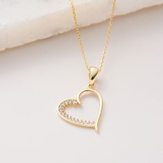 "Channel set Cz and Half Plain Heart Pendant, Solid Gold 10K 14K 18K, CZ Simulated Diamond  Necklace, Pendant Jewelry for everyday wear  Sizes of the *Hexagon Star Heart Pendant* * 0.5inch /  13mm (excluding bail) * 0.7inch /  18mm (including bail) * 100% 10K 14K 18K Solid Yellow Gold (Not Gold Vermail or Not Gold Plated) * Price includes the chain when \"Pendant and Chain option\" is chosen. * Cubic Zirconia clear simulated diamonds * Channel set Cz and Plain Heart Pendant is a lightweight item. * Polished finish EU and UK taxes; *EU and UK orders over £135/€150 are subject to customs, import duties and tax charges once they reach their destination. This means that the recipient will be responsible for all customs, import duties and sales taxes that may apply at Eu or UK to the purchase. Gold Heart Pendant Necklace With Brilliant Cut, Gold Cubic Zirconia Open Heart Necklace, Gold Open Heart Cubic Zirconia Necklace, Gold Cubic Zirconia Heart Necklace Fine Jewelry, Yellow Gold Heart Cubic Zirconia Necklace, 14k Gold Heart Cut Necklace For Wedding, Gold Open Heart Necklace With Brilliant Cut, Gold Plated Heart Necklace Fine Jewelry, Hallmarked Fine Jewelry Heart Necklace