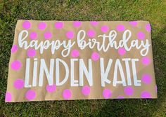 a birthday sign that says happy birthday linden kate on it in pink and white polka dots