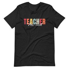 Elevate your favorite teacher's wardrobe with our vibrant Personalized Teacher T-Shirt! Crafted with care and designed to celebrate the dedication and passion of educators, this tee features a striking "Teacher" typography in an array of cheerful colors, sure to brighten up any classroom. Each shirt is made to order, allowing you to add that special touch by personalizing it with the teacher's name underneath the colorful "Teacher" design. Whether it's a beloved mentor, a cherished colleague, or Back To School Teacher Gift Shirt With Text Print, School Spirit T-shirt With Name Print For Teacher Appreciation, Short Sleeve T-shirt With Name Print For Teacher Appreciation, School Spirit T-shirt With Text Print For Teacher Appreciation, Back To School T-shirt With School Spirit Style, School Spirit T-shirt For Back To School, Back To School T-shirt With Text Print For Teaching, School Spirit T-shirt Relaxed Fit For Back To School, Pre-shrunk Graphic Tee For Teacher Appreciation