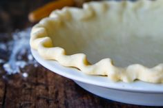 an uncooked pie crust on a white plate