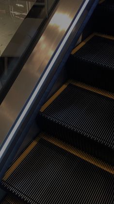 an escalator that is next to some stairs