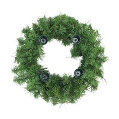 a christmas wreath with green decorations on it and two black plastic balls in the center