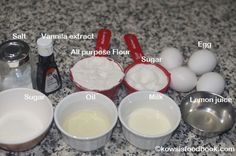 ingredients to make an egg muffin laid out on a granite counter top, including eggs, milk, sugar, and vanilla