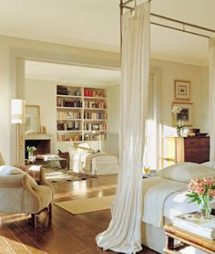 an instagram photo of a bedroom with a canopy bed and couches in it