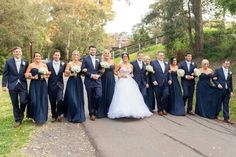 a group of people that are standing in the street together and posing for a photo