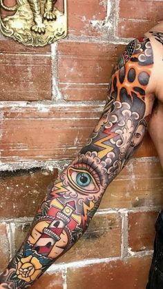 a man's arm with an all seeing tattoo on it