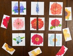 paper flowers are laid out on a wooden table with cards attached to the boards and cut into squares