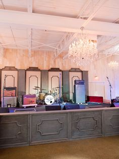 an empty room with several guitars, drums and other musical equipment on the counter top