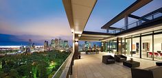 an outdoor living area overlooking the city at night