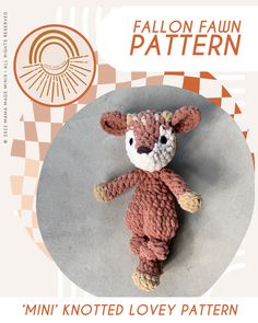 a knitted teddy bear sitting on top of a table next to an orange and white checkered background