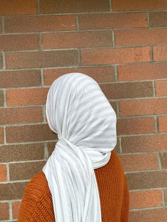 A perfect hijab for year round wear! Super icy cool tones for winter and also the perfect feel for spring and summer. Premium jersey hijab made in limited edition prints. Available in two hijab styles! Fabric content: Viscose and spandex. Woven yarn dyed. Color: Eggshell white and light blue-ish heathered grey stripes. Pattern placement may vary. Feel: Light weight and silky feeling. Requires an under cap. Semi transparent due to the color. Available styles: Slip-on or regular wrap style. Measur Casual Cotton Hijab, White One Size Casual Headscarf, White Casual One-size Headscarf, Casual White One Size Headscarf, Casual White One-size Headscarf, Eggshell White, Jersey Hijab, Hijab Styles, White Slip