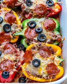 a casserole dish filled with pepperoni, cheese and black olives on top