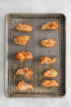 chicken wings cooking on a grill in an oven