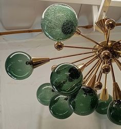 a green chandelier hanging from the ceiling