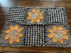 four patchwork sunflowers are on the table