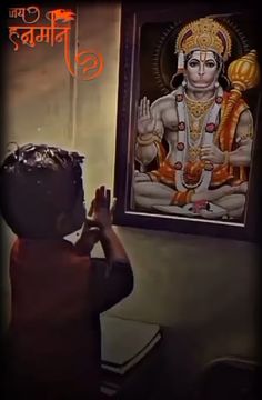 a little boy standing in front of a painting on the wall with his hands up