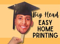 a man wearing a graduation cap and holding up a paper mask with the words, big head easy home printing