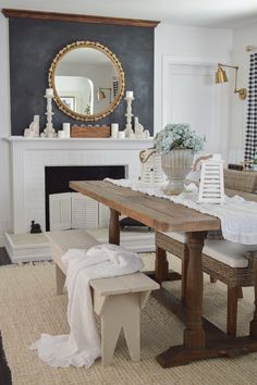 a dining room table with chairs and a mirror on the wall above it that says fox hollow cottage