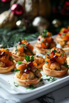 small appetizers are arranged on a platter with christmas decorations in the background