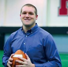 a man holding a football in his hands