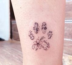 a small dog paw tattoo on the leg