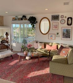 a living room filled with lots of furniture next to a large window covered in pictures