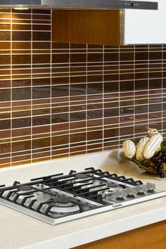 a stove top oven sitting inside of a kitchen next to a wall mounted range hood