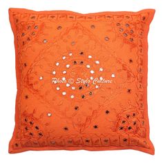 an orange pillow with sequins on it