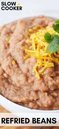 a white bowl filled with refried beans and cheese