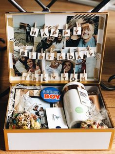 an open birthday box with pictures and letters