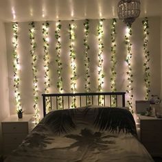 a bedroom with lights on the wall and a bed