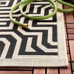 a green stethoscope laying on top of a black and white rug