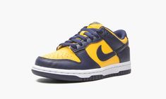 The Nike Dunk Low GS “Michigan” is the youth sizing of an original Dunk colorway that was originally produced for the Michigan Wolverines college basketball team in 1985.  Debuting in 1985’s “Be True to Your School” pack of college basketball inspired Dunks, the “Michigan” was brought back in high-top form by Nike to much fanfare in September 2020.  The equally popular low-top edition follows the same color block as the original and high-top version of the “Michigan. ” Varsity Maize leather can Michigan Dunks, Dunk Low Michigan, Michigan Wolverines Basketball, Nike Casual, School Pack, Retro Basketball Shoes, Yellow Nikes, Basketball Team, Maize