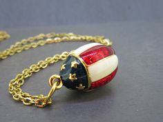 "Vintage Joan Rivers enamel egg pendant necklace with an 18\" chain.  It has a patriotic flag style with stars and blue enamel on top with red and white stripes down the side.  Great piece! All items added to your cart at Ribbons Edge will automatically combine shipping. To stay up to date with my newest offerings, follow me on IG @ RibbonsEdge" Patriotic Nickel-free Jewelry For 4th Of July, American Flag Jewelry For Independence Day Gift, Patriotic American Flag Jewelry Gift, Patriotic American Flag Jewelry For 4th Of July, American Flag Jewelry For 4th Of July Gift, American Flag Jewelry For 4th Of July, American Flag Jewelry Gift For 4th Of July, Patriotic Flag, Joan Rivers