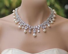 "If you love Hollywood glamour, here's the wedding jewelry you've been searching for. The sparkling, crystal and pearl design of the 'Juliette' necklace features marquise and round shaped crystals in an eye-catching statement style. With Swarovski pearls dotted throughout the necklace, it will take your breath away. ❣ If you would prefer an all crystal necklace please select from pearl color menu. ❣ Available in rose gold, silver (rhodium) and gold. ❣ Necklace measures 17\" ❣ Nickel-free and non Pearl White Crystal Bridal Necklace For Wedding, Bridal Necklace With Pearl Drop For Wedding, Crystal Bridal Necklace With Pearl Drop For Anniversary, Anniversary Crystal Bridal Necklace With Pearl Drop, Pearl White Crystal Bridal Necklace For Anniversary, Crystal Pearl Drop Necklace For Wedding, Crystal Pearl Drop Necklace For Anniversary, Statement Wedding Jewelry, Crystal Wedding Necklace