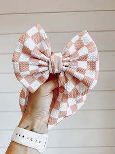 This Checkered Fancy Bullet Bow is the ultimate accessory for your little nestling. Crafted from durable bullet fabric, the Fancy bullet bow headwrap is designed to maintain its shape without sagging. Perfect for bringing home baby outfit, all the way to summer adventures! color: Peach Checkered fabric type: Bullet Our Fancy Bullet Bows come in the following options: **Headwrap (5inch bow) **Nylon (5inch bow) **Clip (5inch bow) **Piggies (two 3inch bows on clips) Headwrap Sizing: -Newborn Headwr Tie Baby Hair Bow, Baby Bow Headband Pattern, Adjustable Detachable White Bow, Playful Adjustable Bow Headband, Playful Bow Headband Hair Accessory, Playful Bow Headband For Gift, Playful Adjustable Bow For Summer, Adjustable Playful Bow For Summer, Playful White Decorative Bow