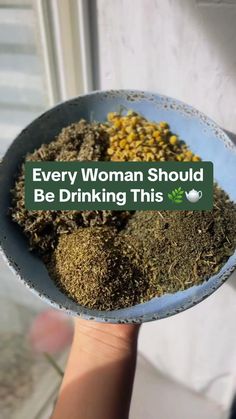 a person holding a bowl filled with different types of spices and herbs that says, every woman should be drinking this